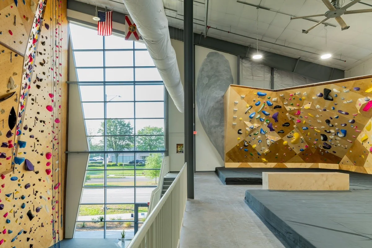 Looking south at colorful bouldering and rope climbing walls.