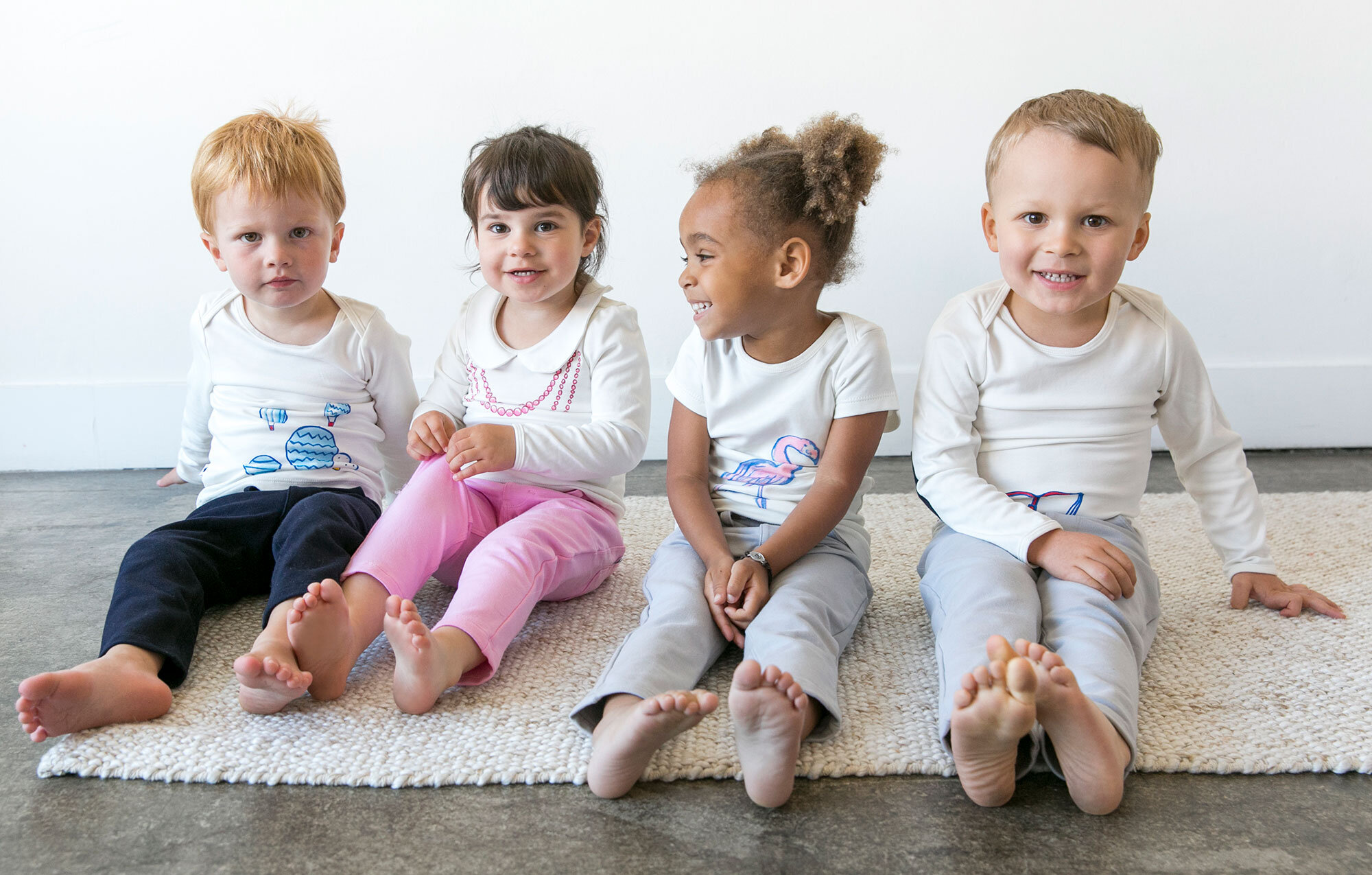 4 kids wearing graphic tees