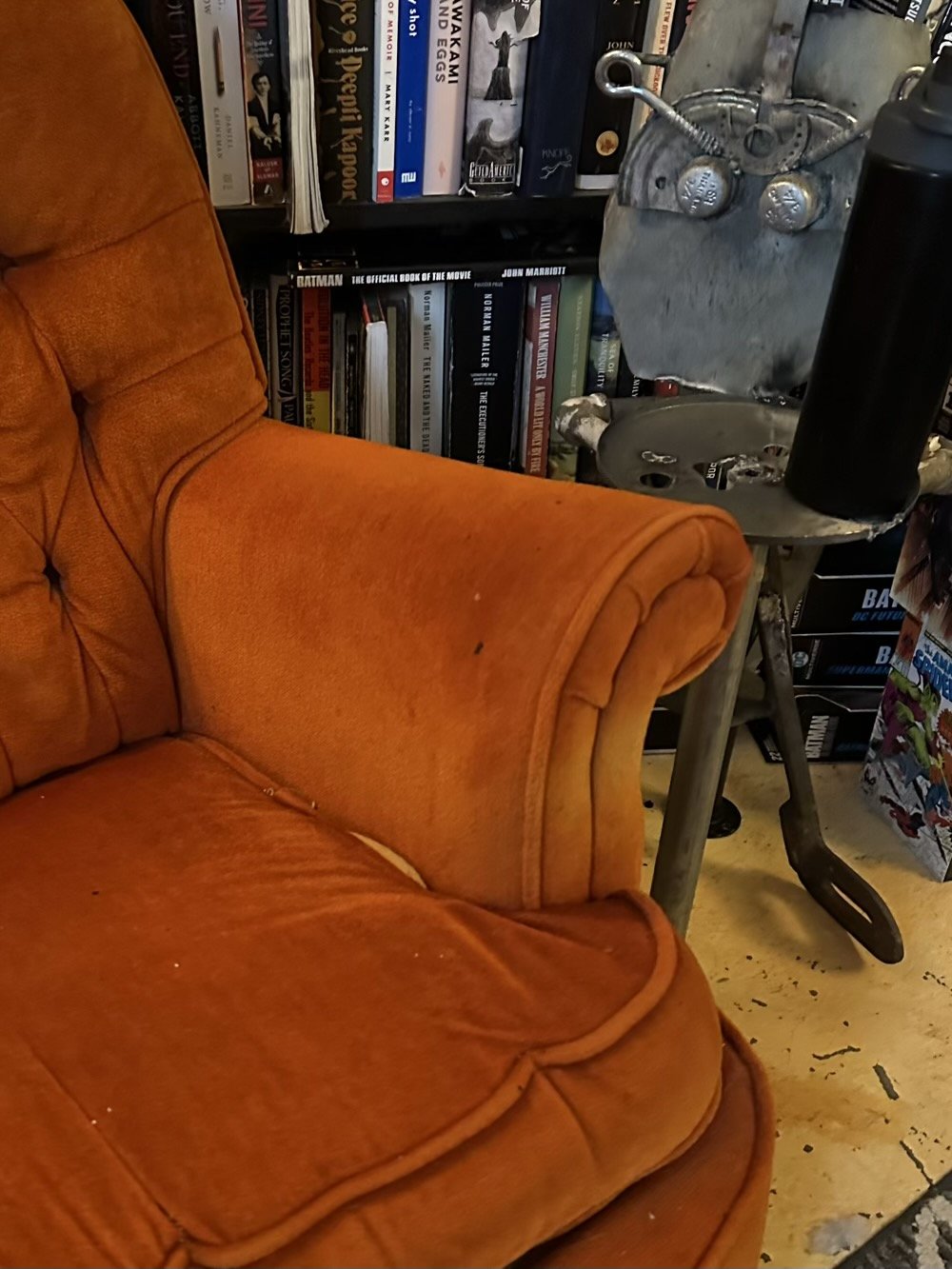 lon the metal guy holds a water bottle next to orangina the chair