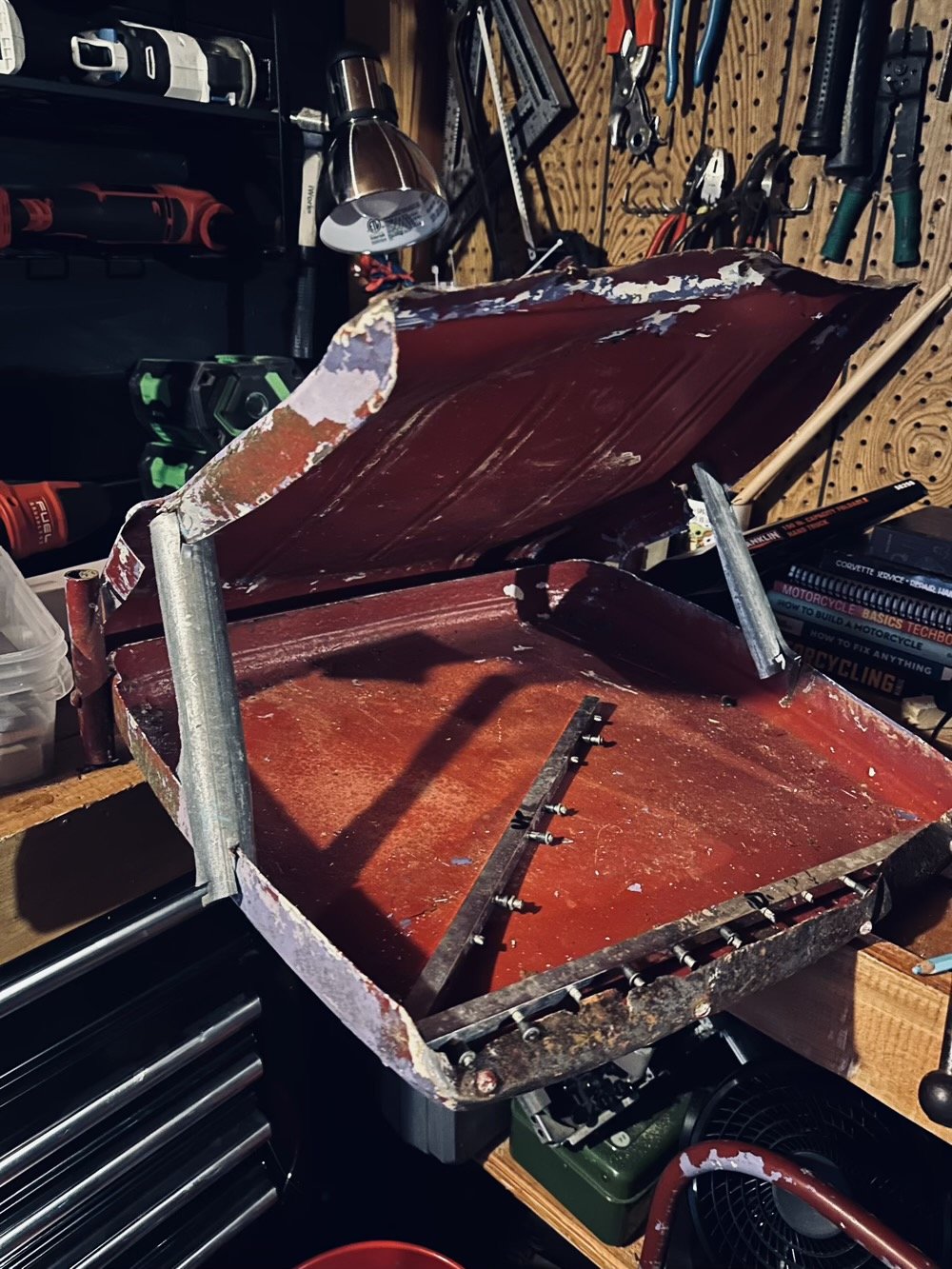 a red chair that now looks like a mouth but has definitely seen better days maybe