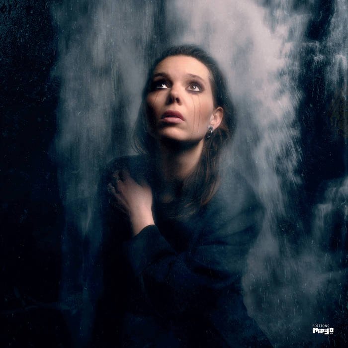 Album cover: tear streaks down a woman's face superimposed against a waterfall