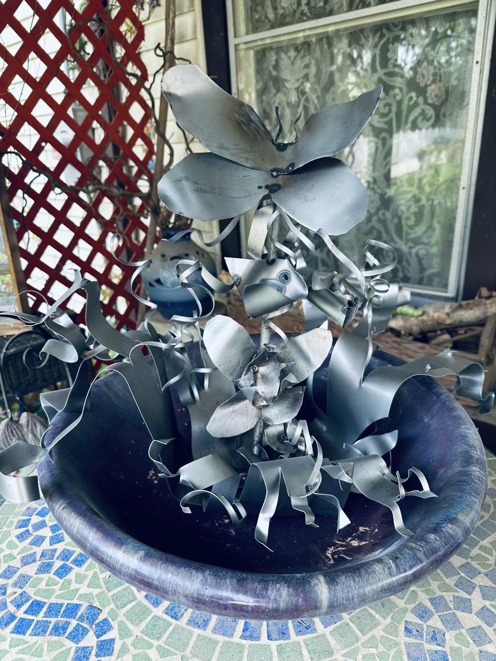 metal flower thing in a huge bird bath