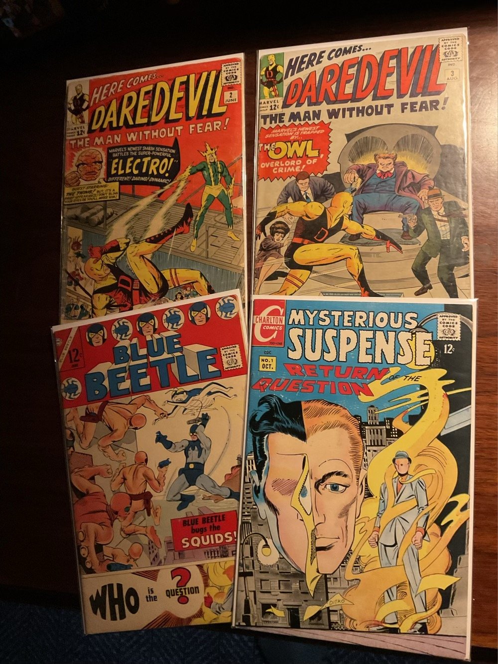Four Silver Age comics, top two featuring yellow suited Daredevil (Issues 2 & 3) and bottom two featuring The Question (1st and second appearances)