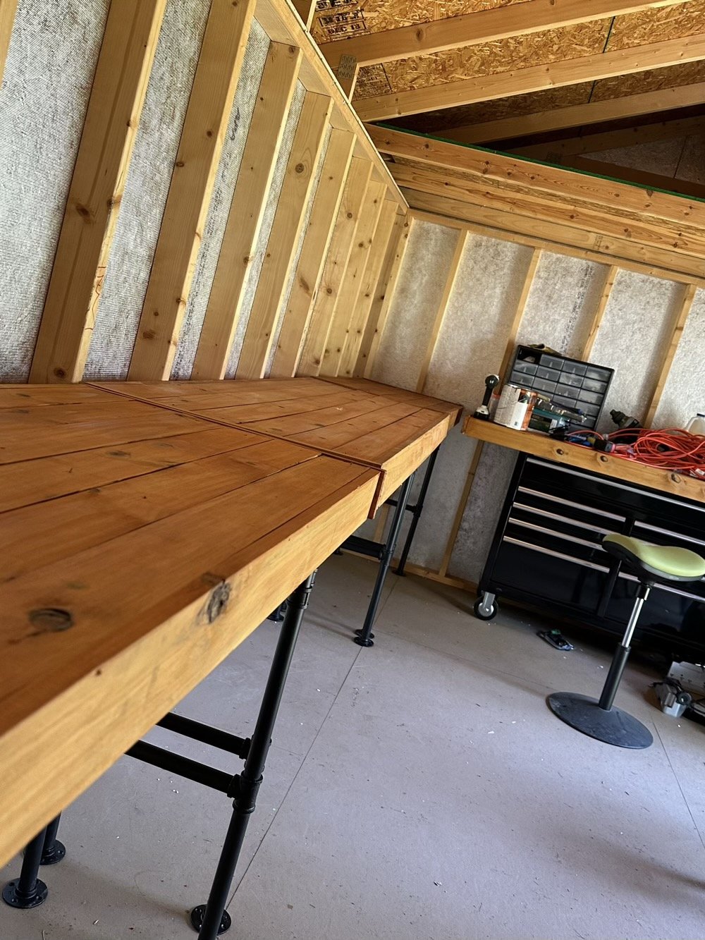 four desktops with industrial pipe legs.