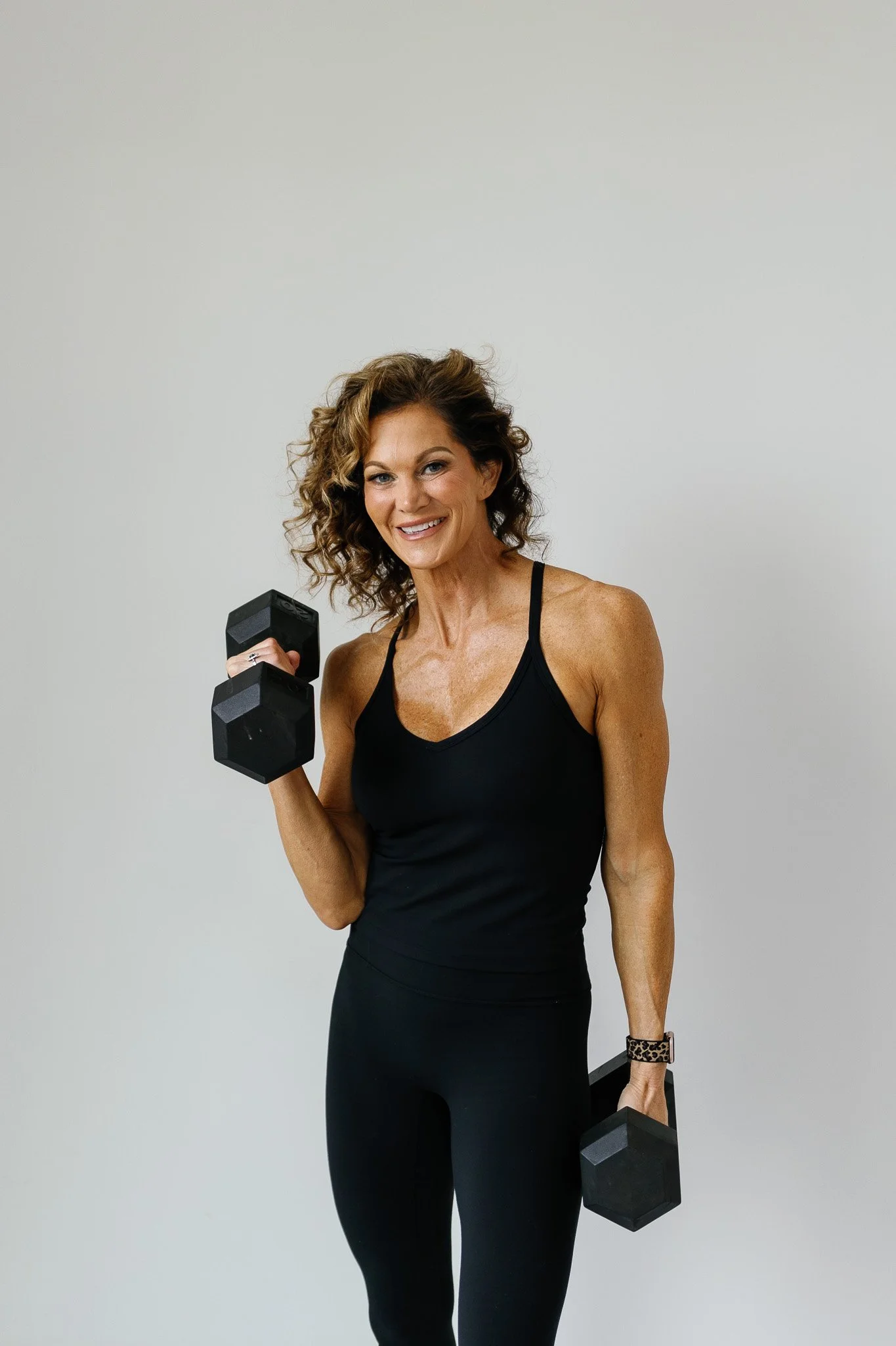 Coach Kerry Hamilton-Gannaway holding dumbbells
