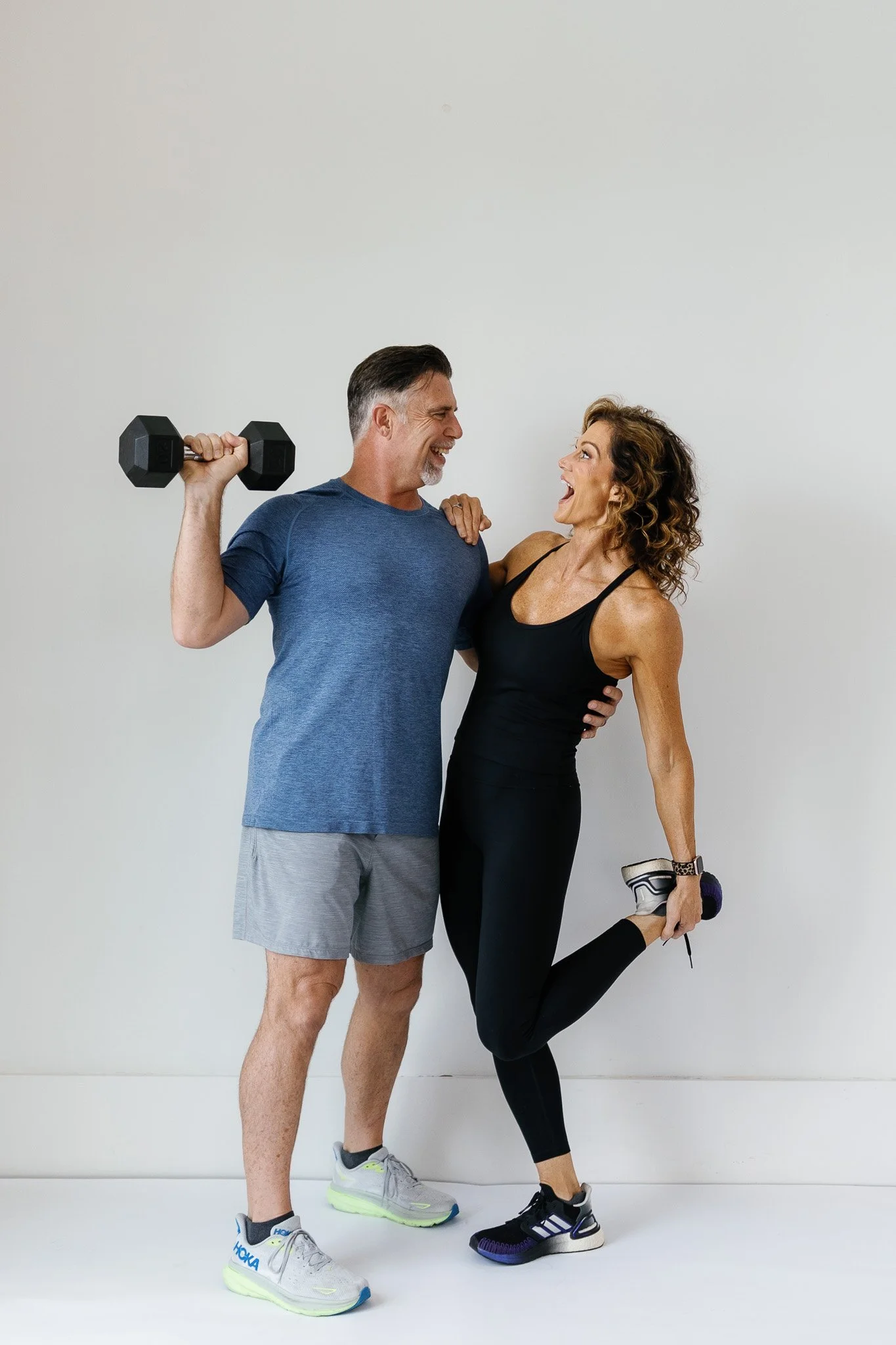 Kerry and Chan smiling together during a strength workout