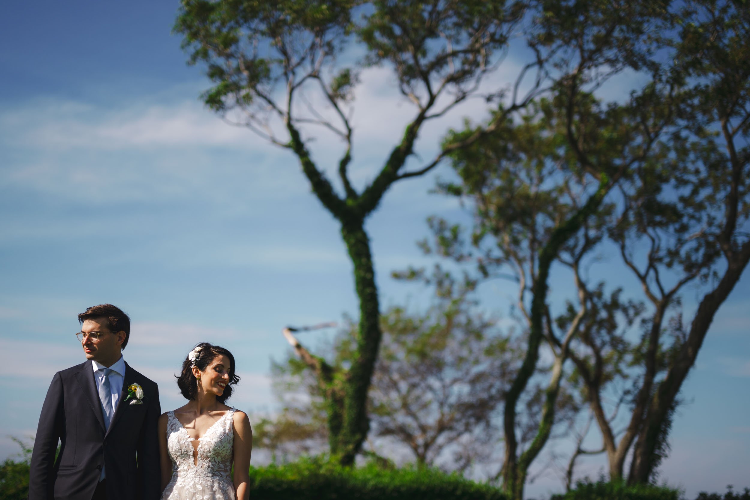  Creative portrait of a couple in front of a blue sky at Old Field Point Lighthouse, Long Island, New York wedding photography 