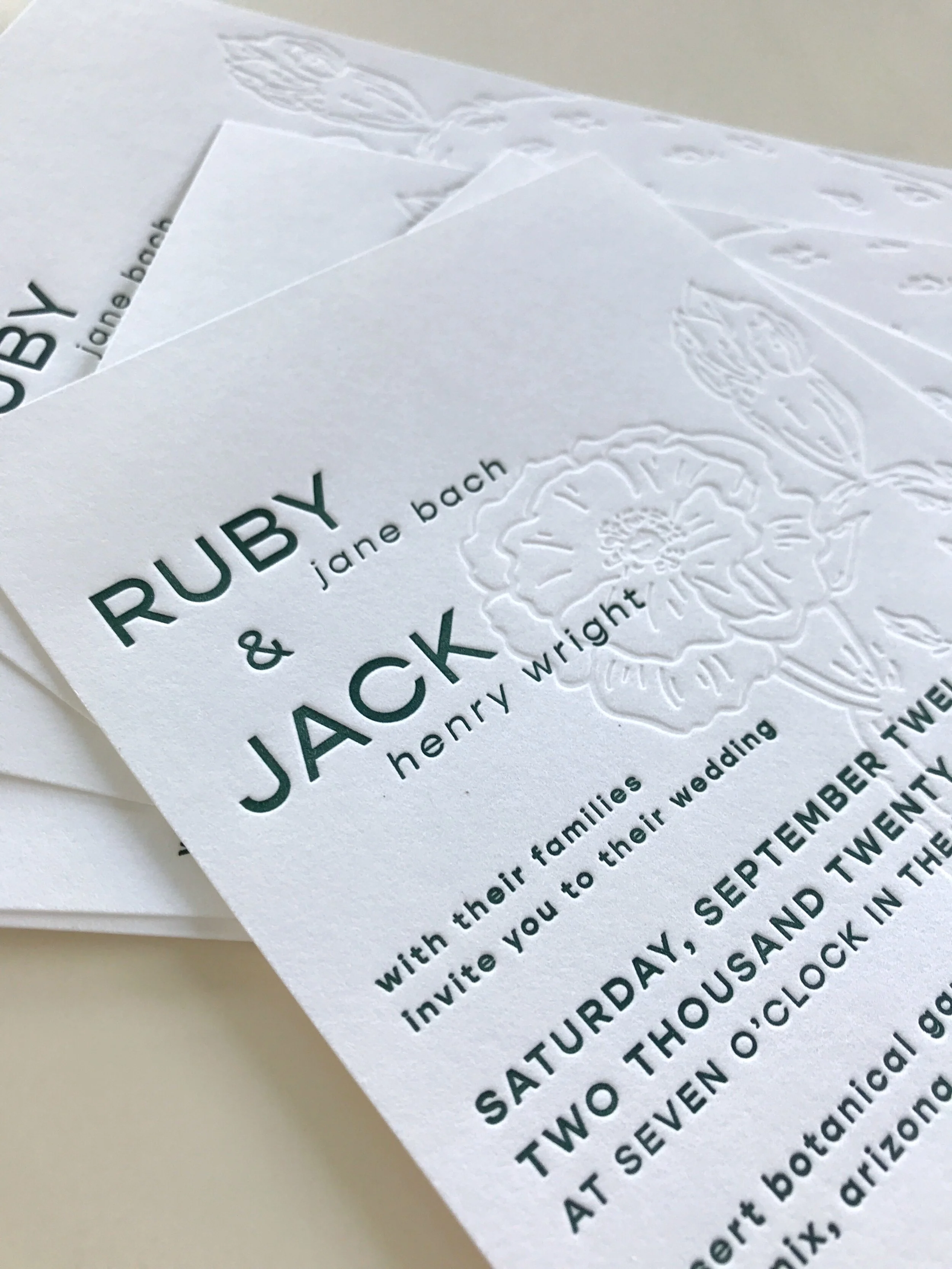 stack of letterpress wedding invitations