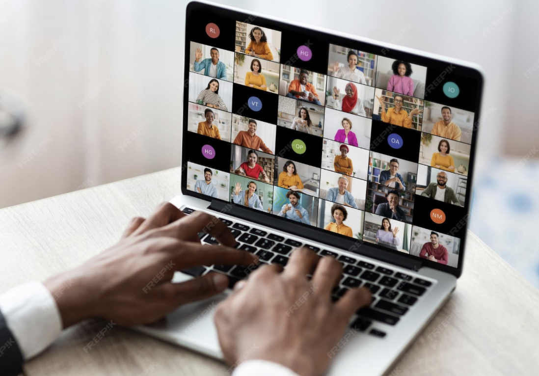Image of a laptop screen that shows a virtual meeting taking place with 36 people (count via the number of people/cubes on the screen)