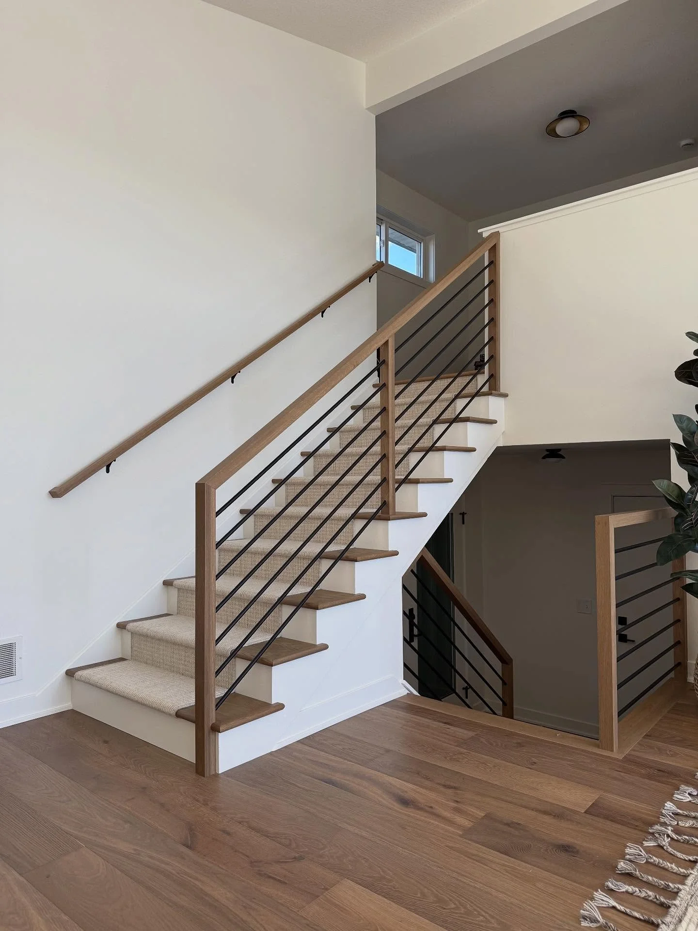This staircase used to close off the space, now it&rsquo;s the highlight of the space. 

We opened up the railing, added wood treads with a rubber, and reimagined the feel to make it cohesive with the rest of the home.  Welcoming, bright, and a total
