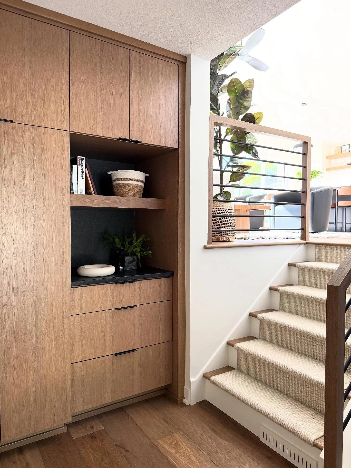 This split-level foyer is tiny, so we had to get creative.  The original bifold-door closet wasn&rsquo;t cutting it&mdash;limited organization and the doors are up valuable space.  We replaced it with a custom built-in featuring hanging storage, a dr