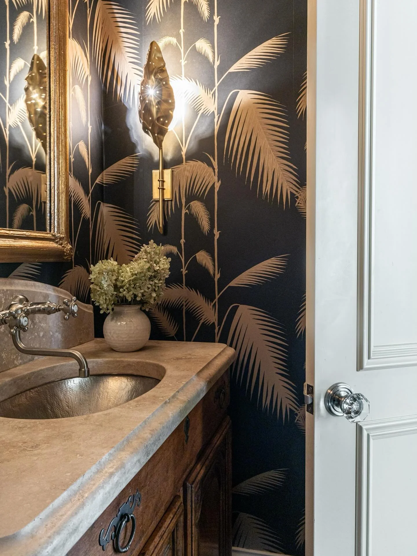 A little drama never hurt a powder room.  We kept the vanity, then amped up the mood with bold wallpaper, a new mirror and lighting that steals the show.

📸: @lakelightarchitecturephoto 
Contractor: @santannicustomhomes