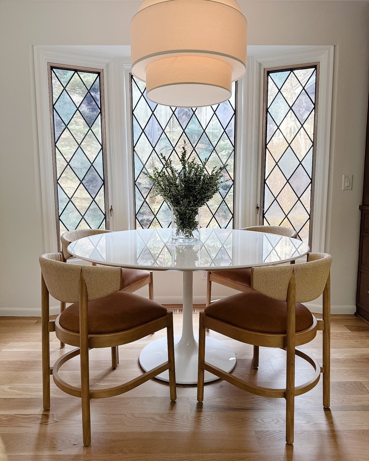 Sweet, cozy, and beautifully simple &mdash; the table, chairs, and light let those original windows and hardwood floors take center stage.