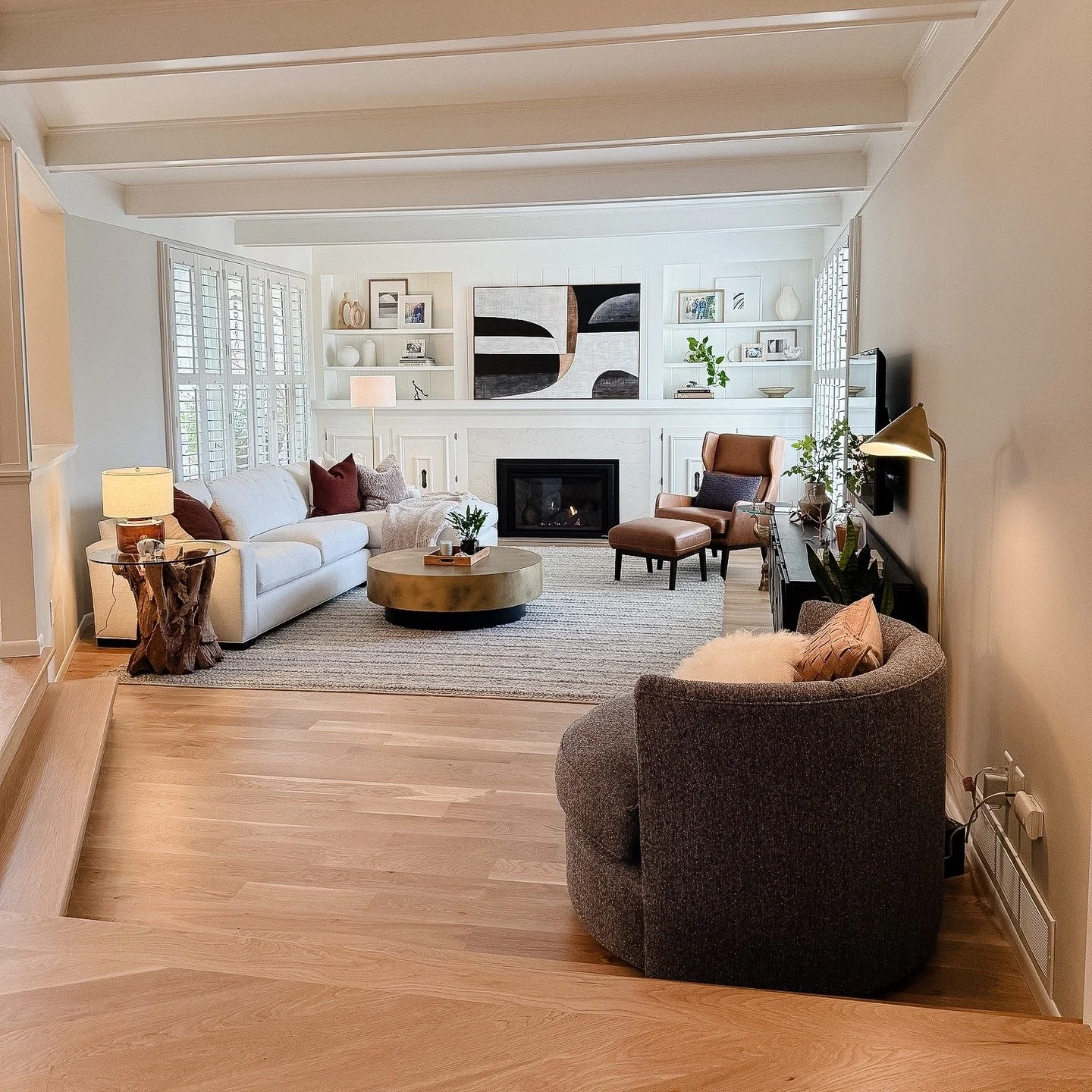 A sunken space feels extra cozy, and with new hardwood + a more intentional furniture layout, this room finally feels open, relaxed, and inviting.