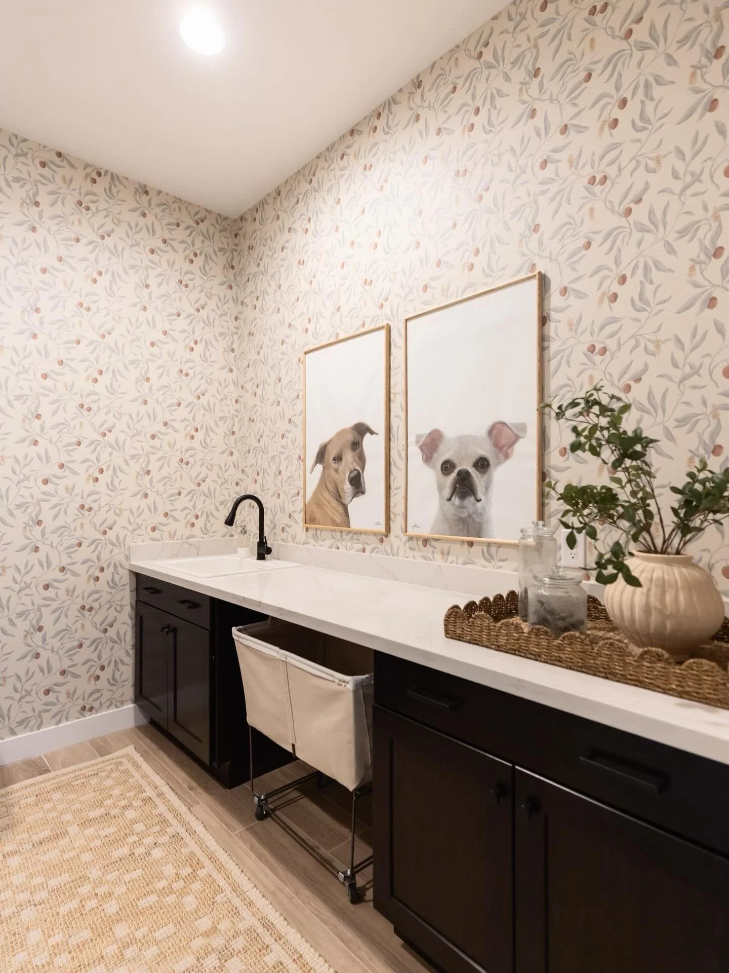 Wallpaper and custom painted portraits of the family pets turned this laundry room into something playful, meaningful, and full of personality.
