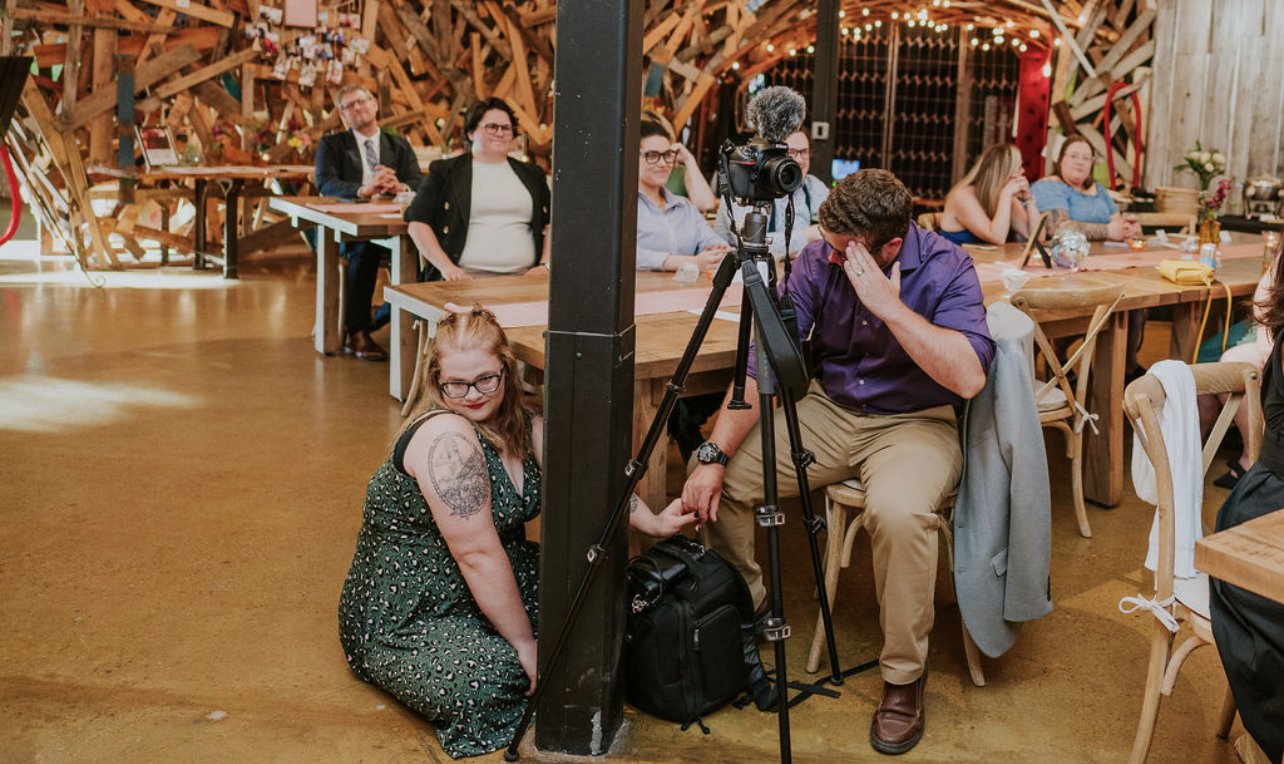 Sarah and Joe being goofy on location video recording a wedding ceremony