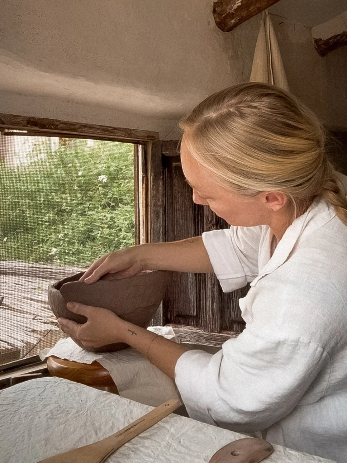 Alexandria Roby owner of Alex Roby Design hand sculpting with clay