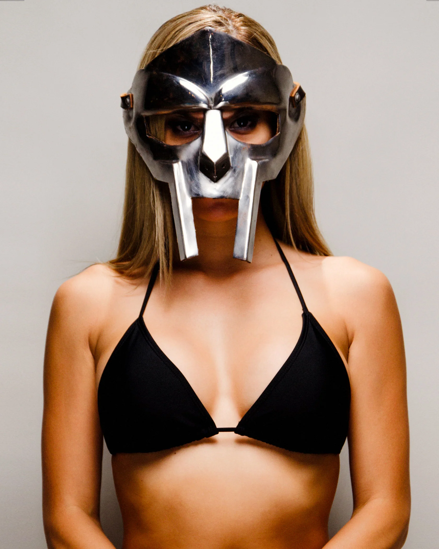 “He cleans his metal mask with gasoline, they after him. Last seen pulling chicks like a fiend pull a fast one” - ? (“Operation Doomsday” 1999) Gladiator mask - “In the beginning he’d throw a bandana, whatever he had to do. His idea was to conceal his identity. For his first shows, we went out and got the cheap Halloween masks you wore when you were a kid with the rubber band around the back. That was Darth Maul. It was red and black. I spray painted it silver aluminum Rustoleum and I cut out the shape and square eyes and made a prototype. Heroics that in his first video, he’s got that. But then what we did was we went out and found the whole helmet from the movie gladiator so I took just the faceplate off and I took it to my boy who does structure and metal. We shaped it a little and I took the webbing from the yellow construction worker helmets. I took just that, which is a band and another band and i fastened the faceplate so that he could wear it and it would actually swivel up… By DOOM keeping his face concealed, he’s able to have a life.” - KEO “Chapter 48 DOOM: KEO and the Villain: FRANK151” by FRANK151 (youtube.com/frank151)