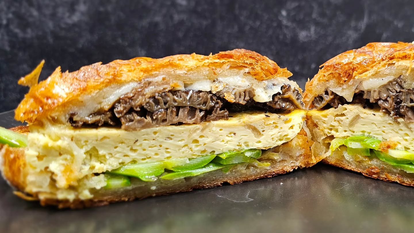 Indulge in our morel breakfast sandwich special! Limited quantities available. Featuring baked egg &amp; shallots, gruyere, asparagus lightly dressed with lemon vinegrette, and an irresponsible amount of morels sauteed in butter, all on a buttery cro