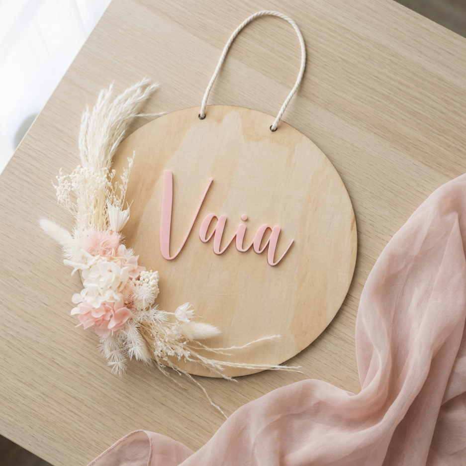 Personalised round timber name plaque with pink acrylic lettering and preserved flowers