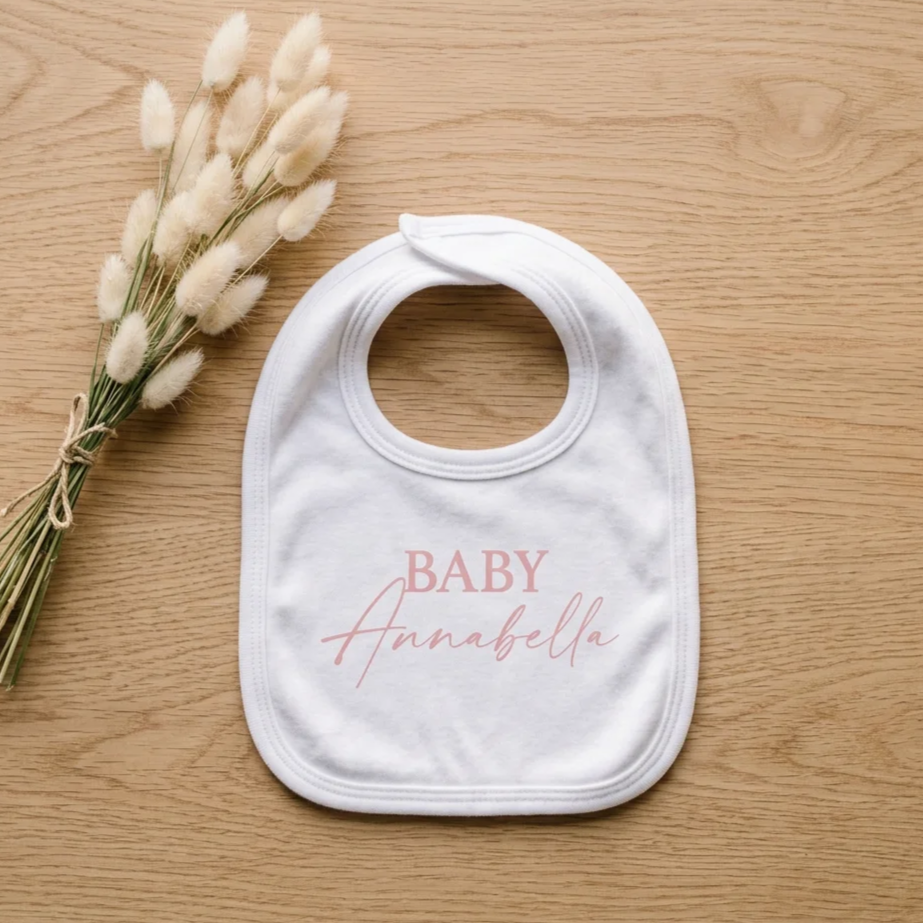 Personalised baby bib with custom vinyl design, suitable for a baby shower or newborn gift.