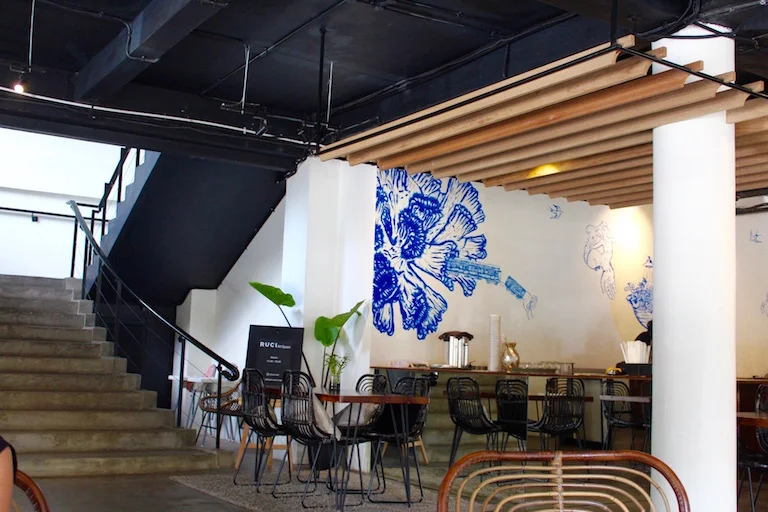 Ruci's cafe space and central stairs that lead to the upstairs Artspace