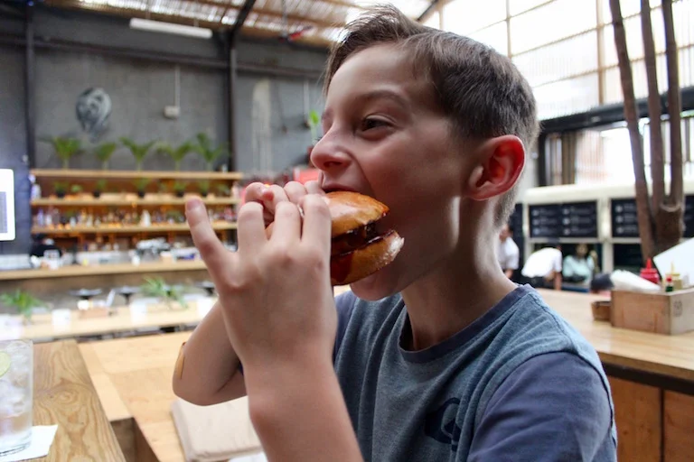 Tom was our blog assistant the day we shot these pics, and here he is enjoying a break and a Three Buns Little Huey burger.