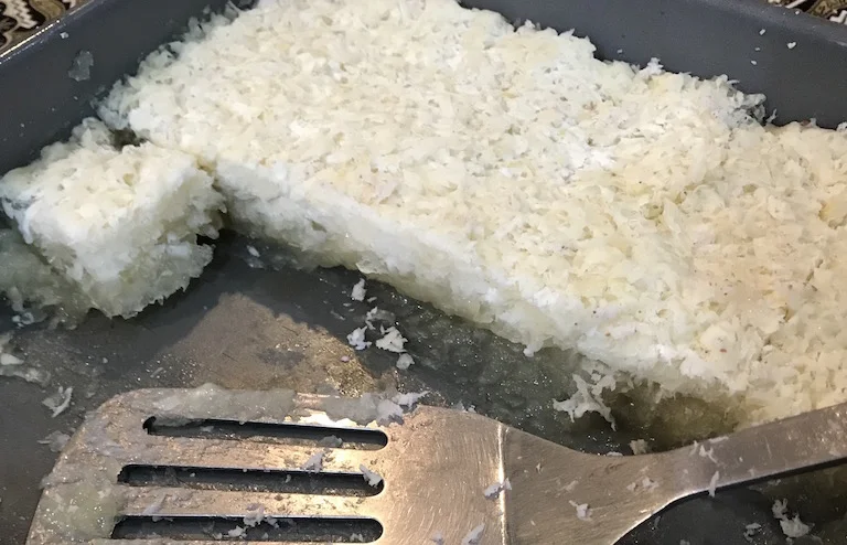 Grated only, the Kue Singkong will appear as two separate layers when steamed. I prefer it this way.. but the more refined version (using a food processor) is also delicious!