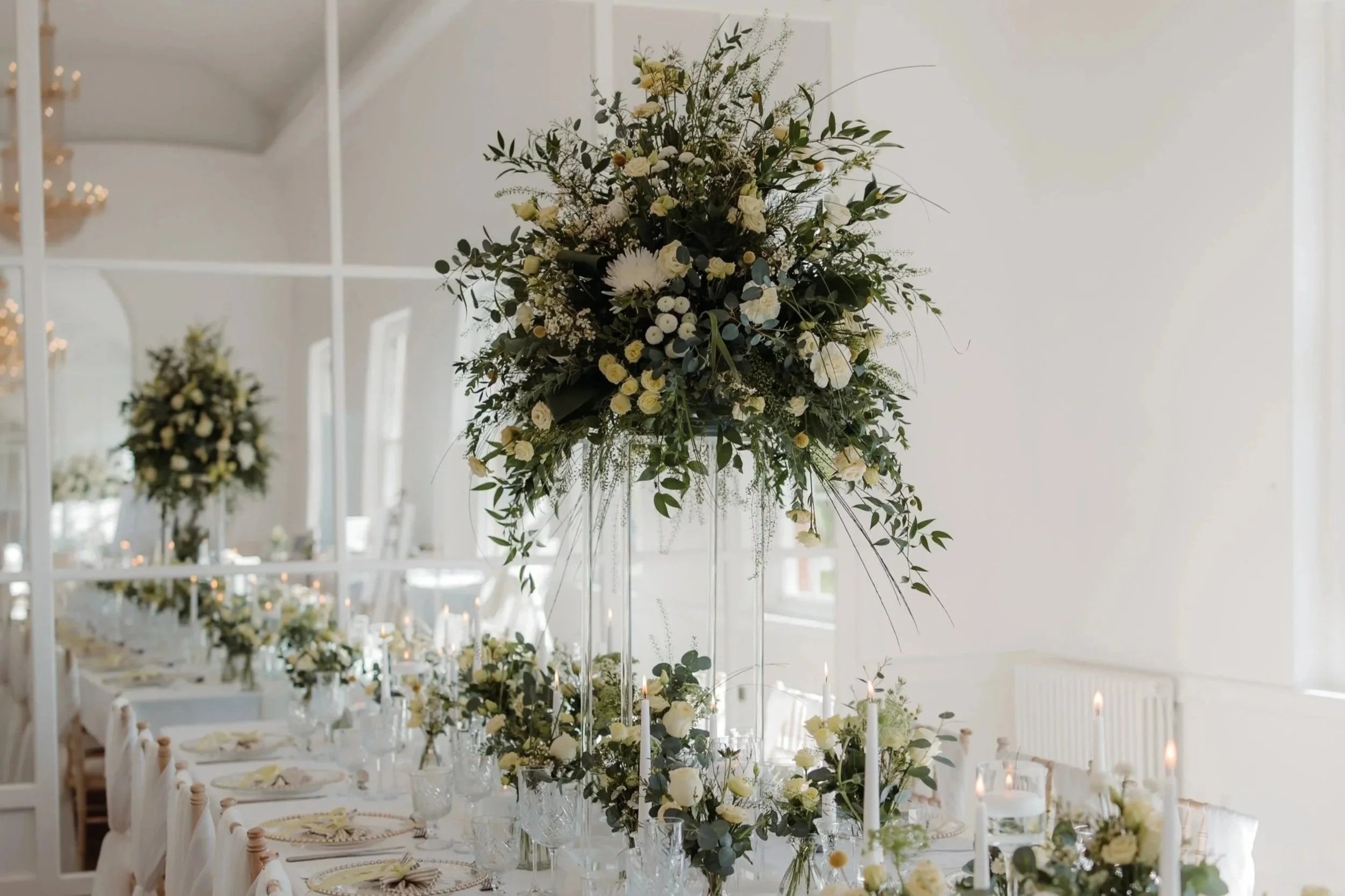 White and Green Wedding Table Flower Arrangements in Wedding Reception Room