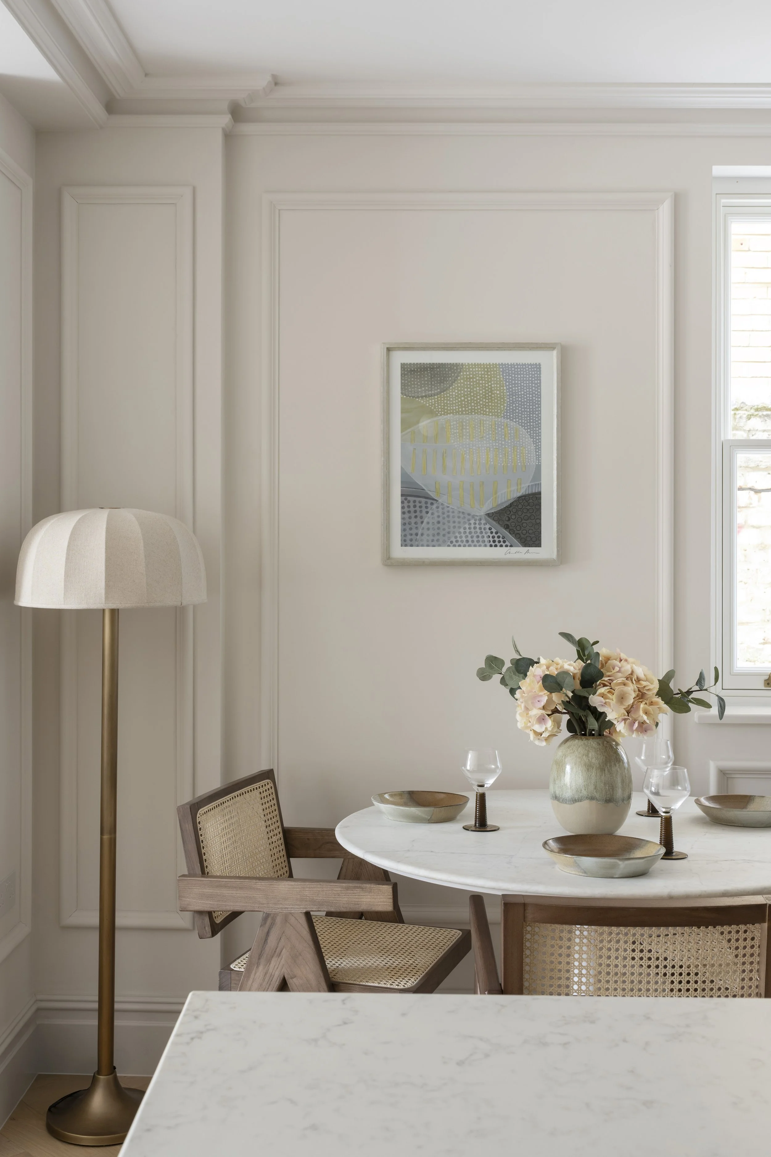 Dining area styled with contemporary furniture and artwork at the Somerset Road development in Ealing.