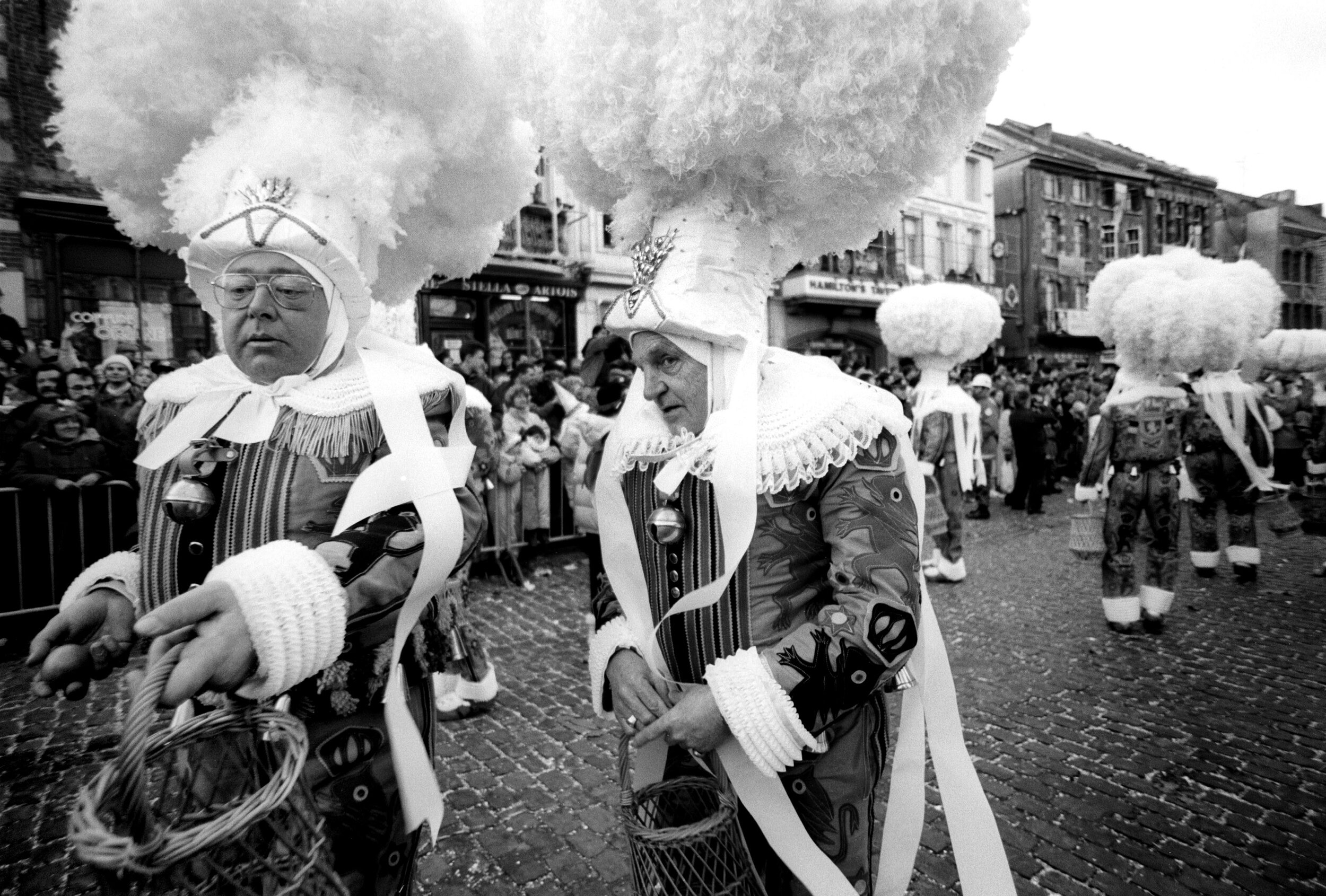  The Gilles of Binche.  During the Shrove Tuesday’s afternoon procession in the city of Binche, the Gille wears his ostrich feathers hat and trows oranges 