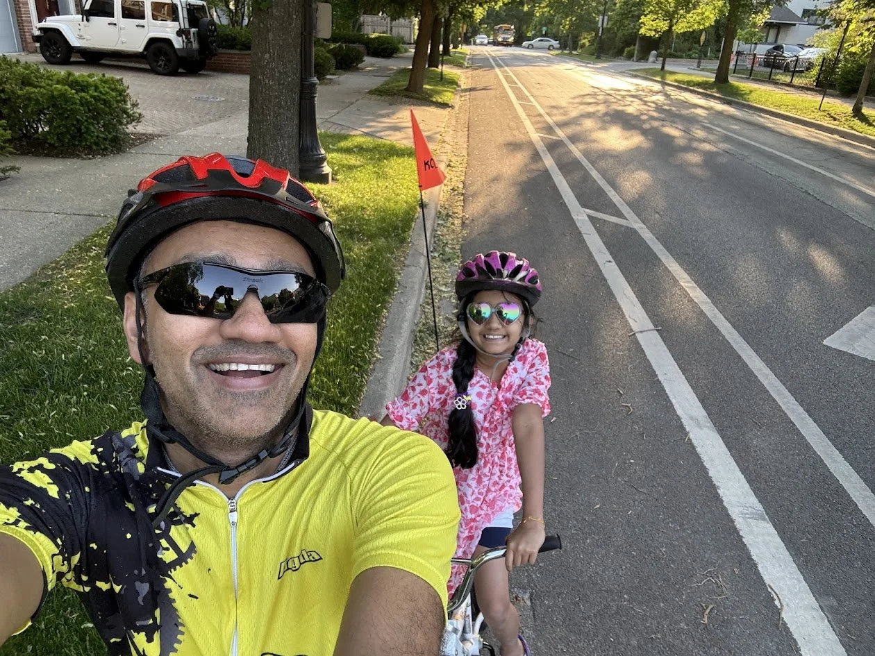Prashant and his daughter on a tandem bicycle