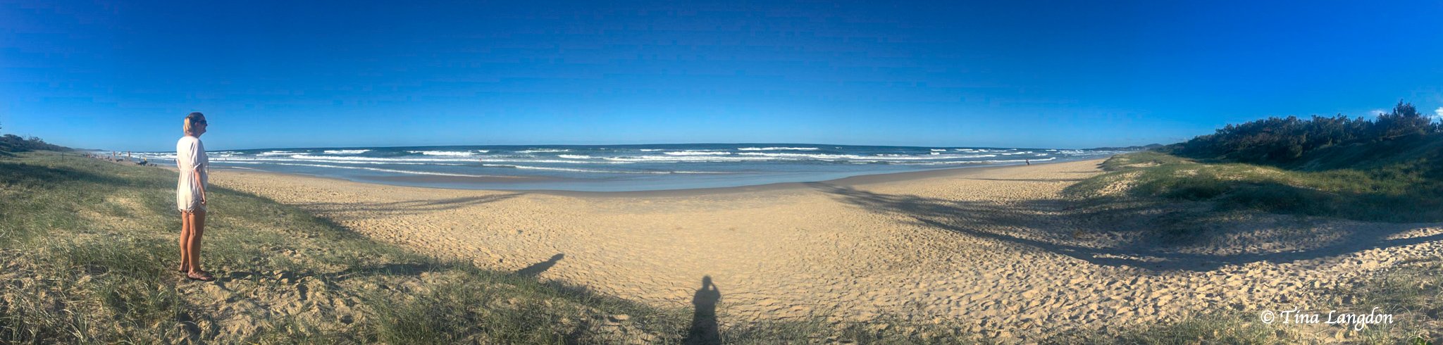 Panoramic photo of lady looking at sea at Peregian beach, Queensland, Australia