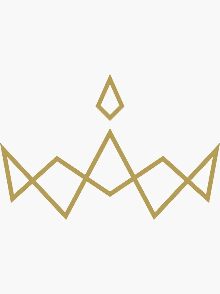 Portrait of a woman with long black hair and red lipstick, wearing a strapless top, leaning her face on her hand against a neutral backdrop.