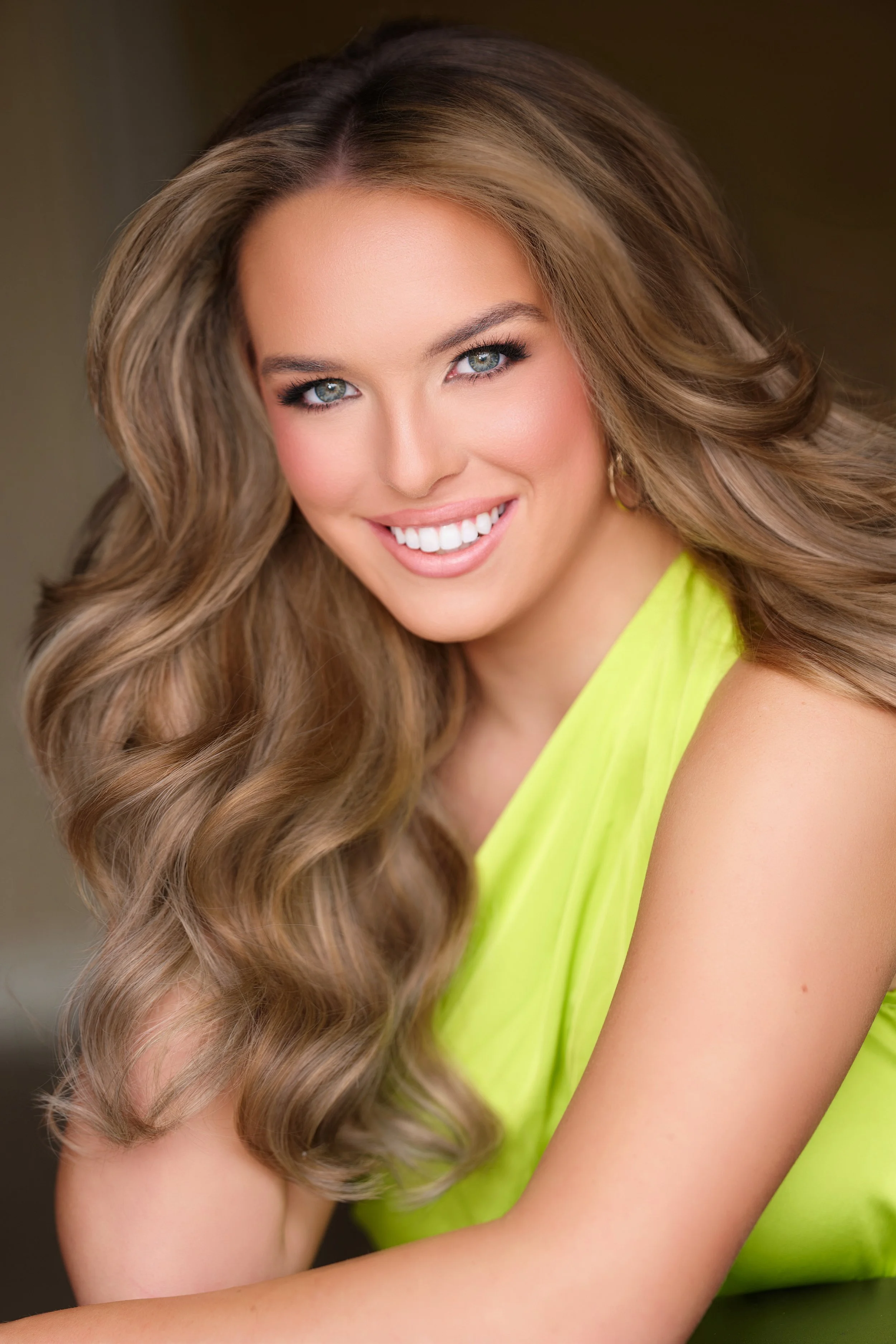 Smiling woman with long dark hair in a blue top