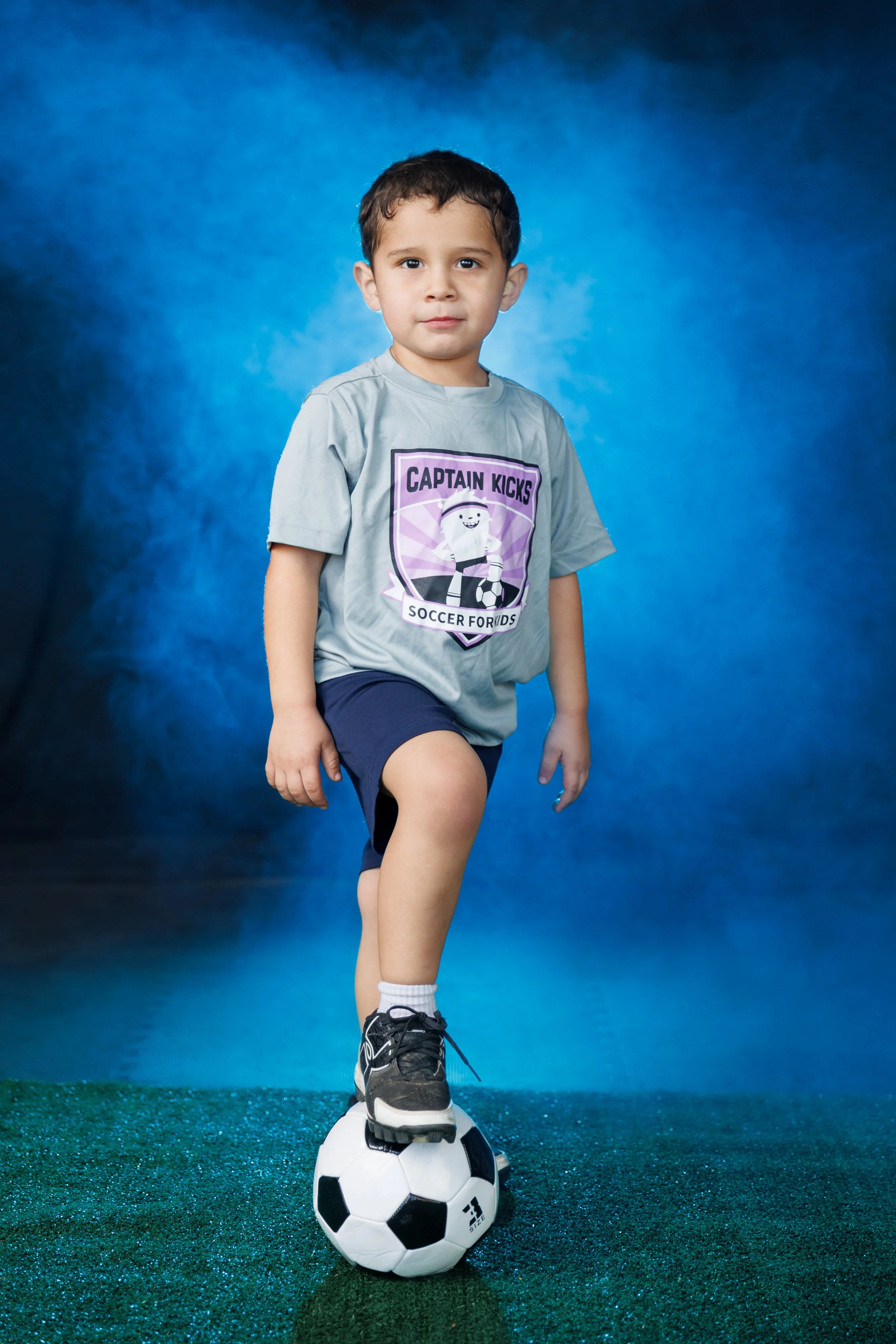 boy posing with soccer ball