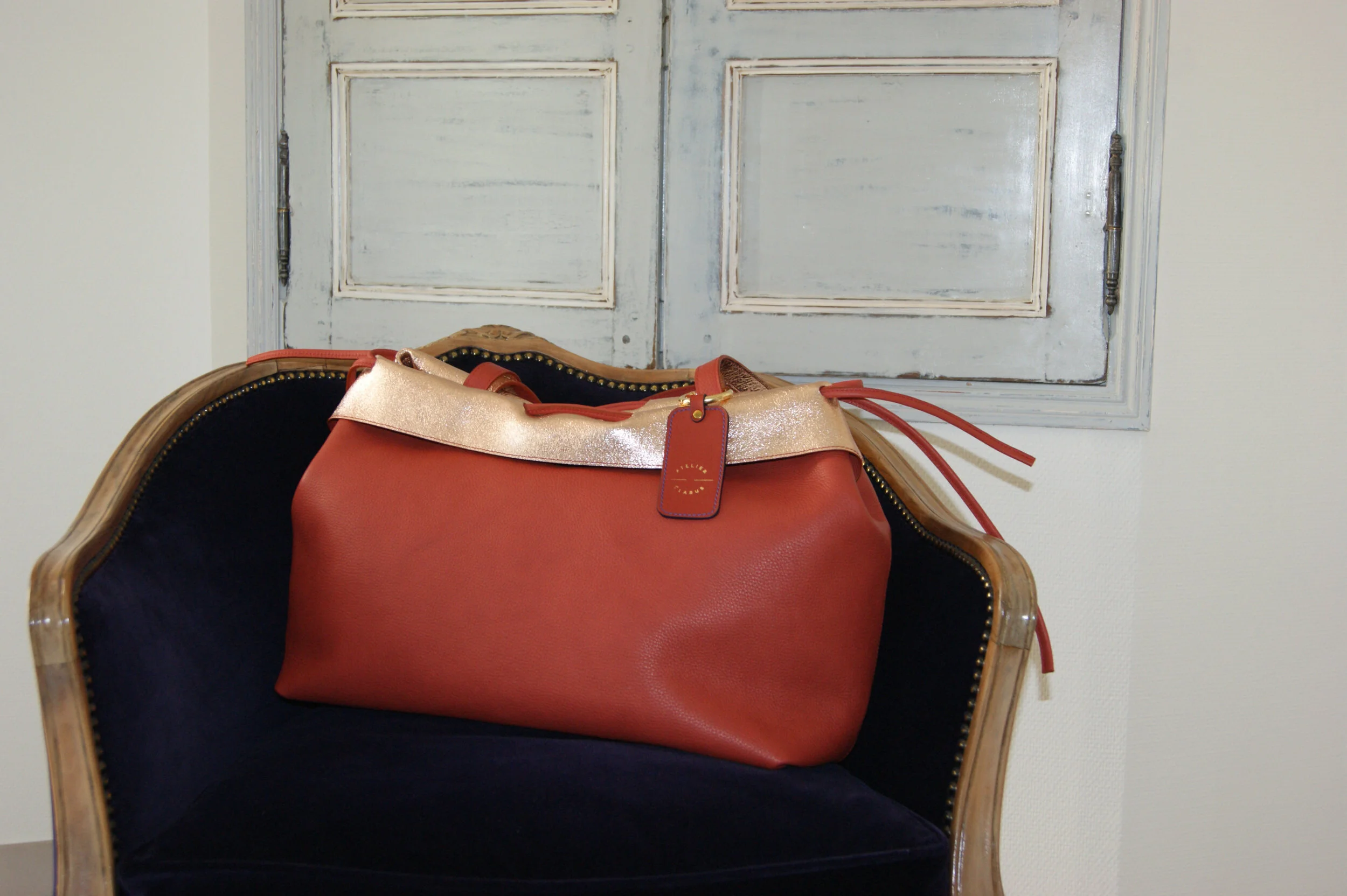 grand sac cuir rouille revers métallisé rose gold signature sur fauteuil