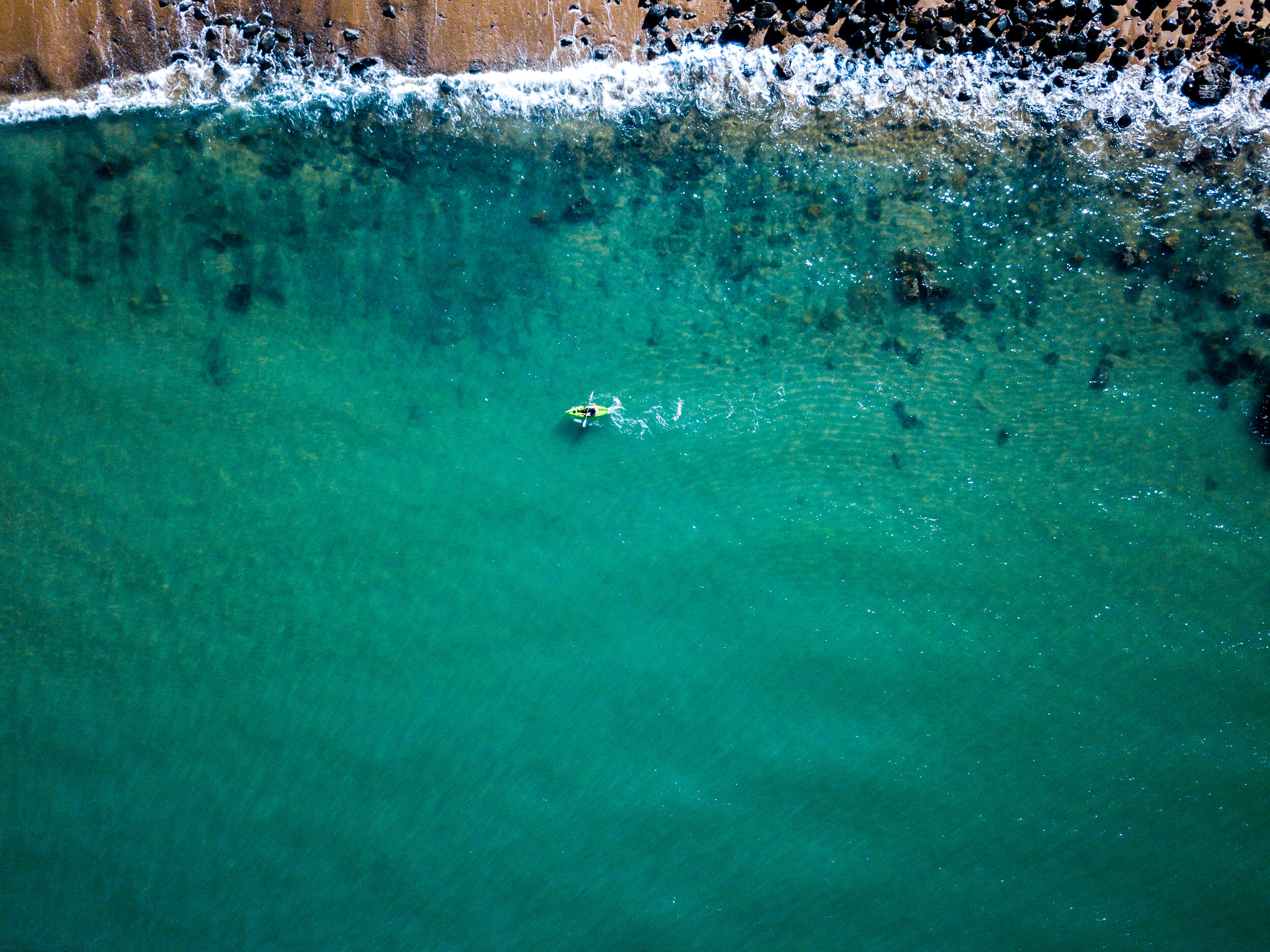 aerial view of a small boat off the coast