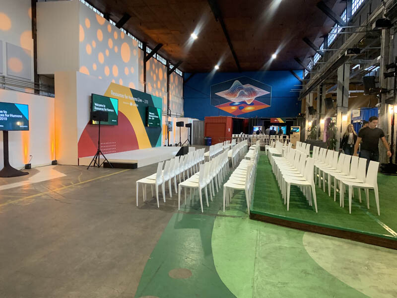 Event stage empty with lighting, chairs and screens ready
