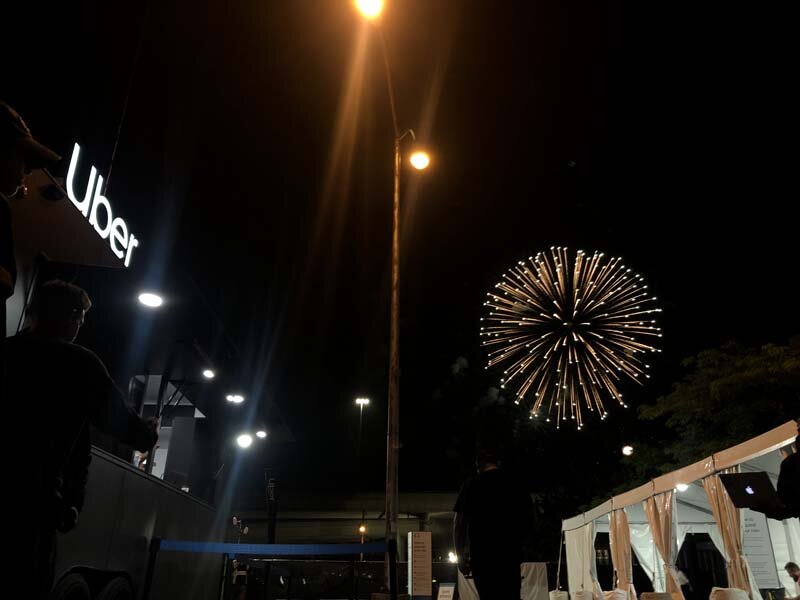 Uber logo light up with with firework at night