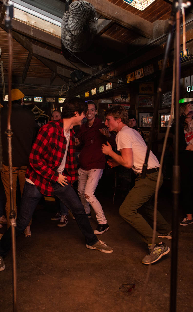  Ted Wharton (left), Max Pelletier (middle) and Collin Spens (left) form a mosh pit to Gorilla Party at The Battle of the Bands on Thursday, November 21, 2019. Wharton, Pelletier, and Spens were in the competing band Cardboard Sailors and supported a