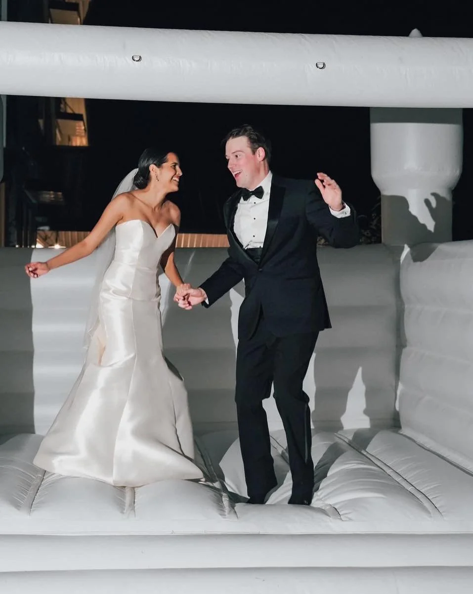 We just thought the main reason we loved the bounce house idea was bc it helped entertained the littles - until these photos showed up- SUCH FUN 🤩 pics of the bride &amp; groom!! Love it! 

Also, shout out to the bride for even hiring 2 babysitters 