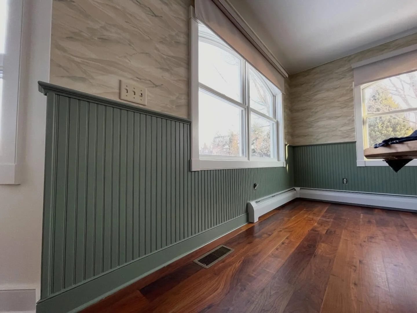 Wainscot with top cap, wallpaper, and Cambridge green to finish it off! Dining room received a facelift along with the island &amp; two main living room walls to bring it all together. Ran into a snag due to the window headers not being flushed out w