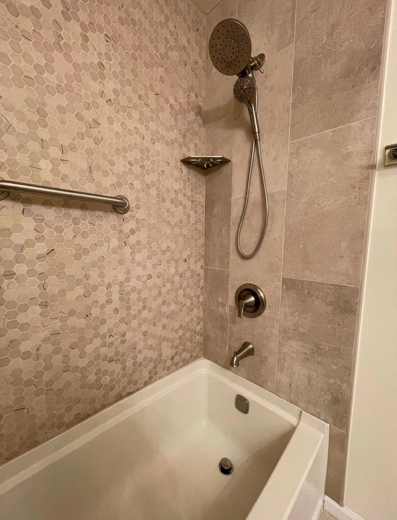 Tub surround replacement. The goal was reuse the tub, add grab bars, new single handle mixing valve, watertight tile backer, and a new modern tile design.