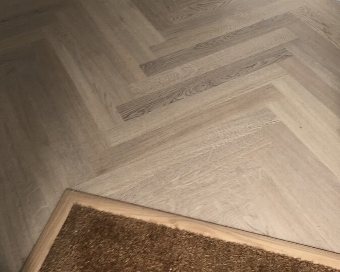 Boen wood floor in herringbone with a mat insert