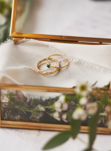 Wedding day image with wedding rings on napkin and wedding floral