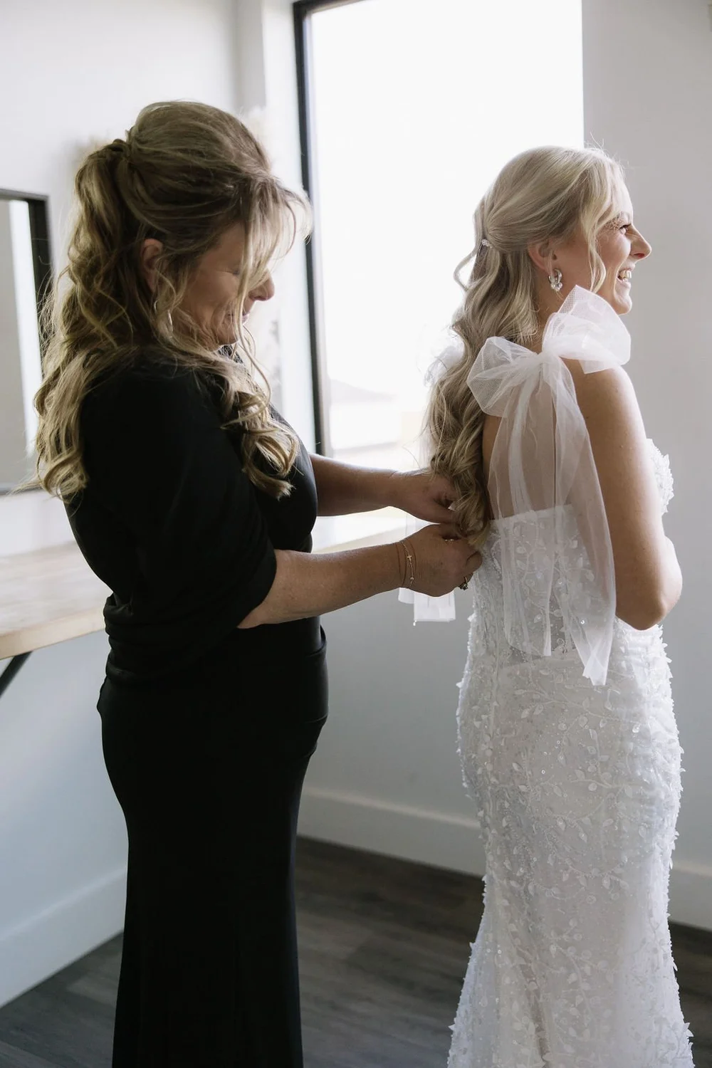 Mom of the bride and bride getting her wedding dress on in the Black Hills, SD