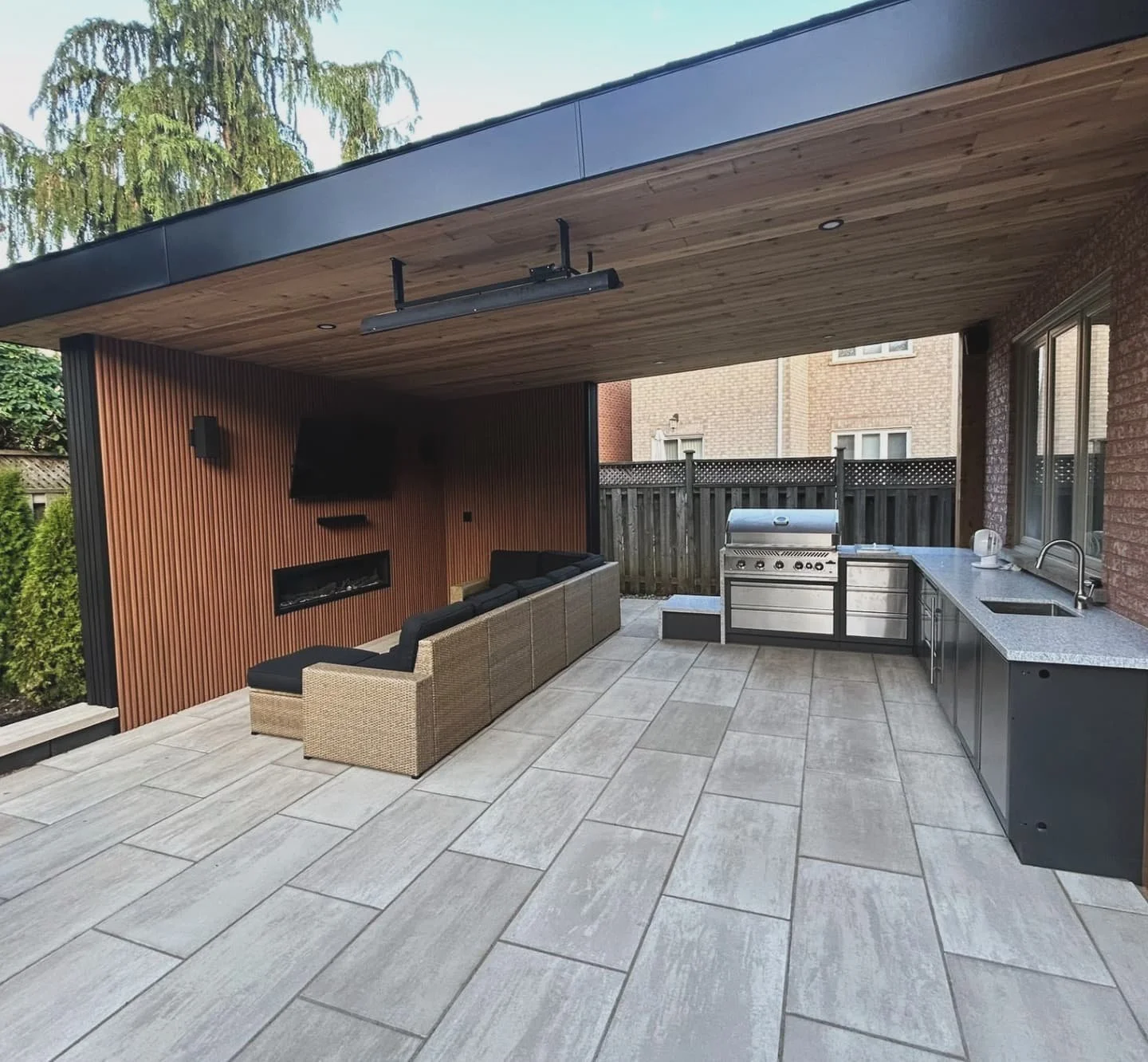 A backyard built for year-round living 🌟
Our latest Halton Landscape transformation features sleek Techo-Bloc Blu Grande pavers in Caf&eacute; Crema, a custom structure with potlights &amp; infrared heaters, a TV feature wall, and a stunning BBQ isl