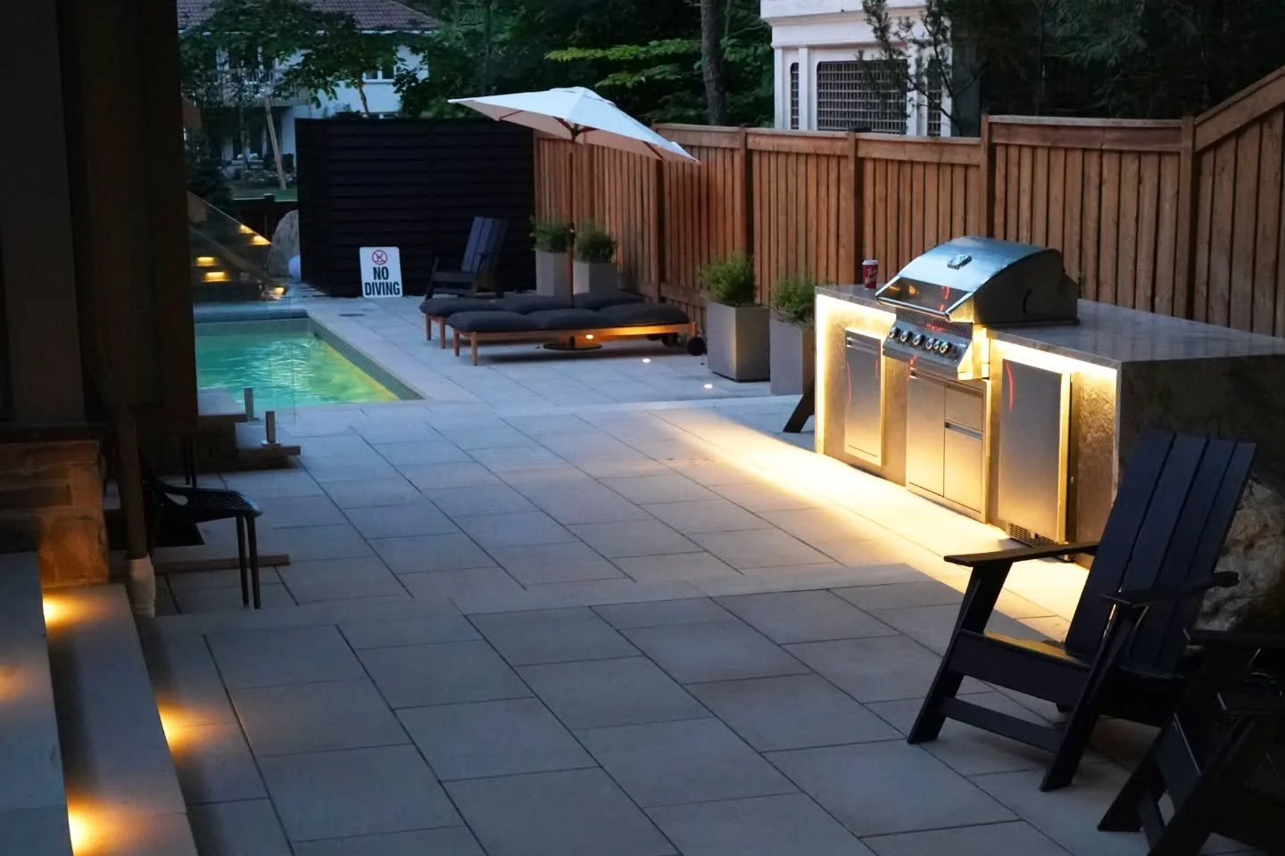 ✨ This custom BBQ grill island, crafted from premium Italian porcelain and topped with a stunning waterfall granite countertop, is the ultimate blend of style and function. Finished with our signature LED light strip for that perfect evening ambiance