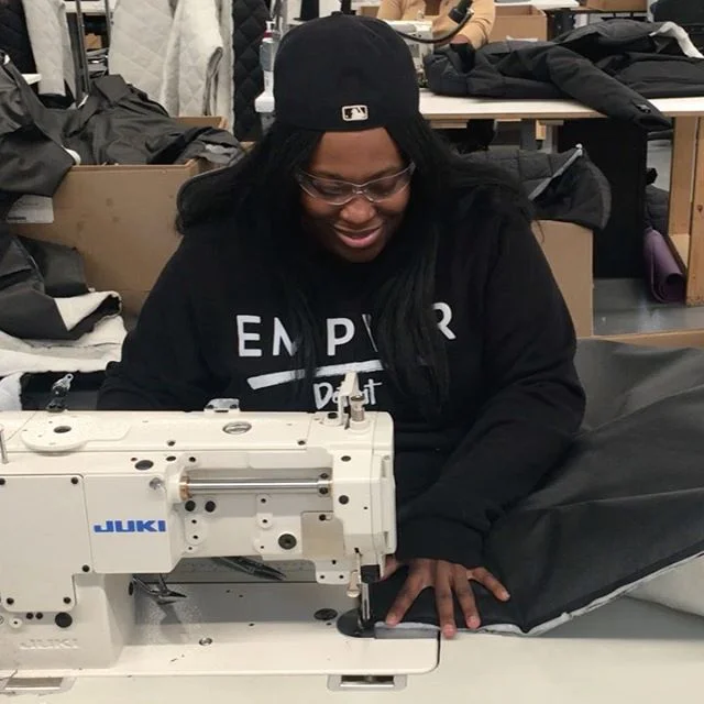 Precision is 🔑 to create the incredible and innovative sleeping bag coat 🧥 from @empowermentplan! Supported by @madonna, #EmpowermentPlan employs formerly homeless women to break the cycle of poverty. The talented Ebonie, seen here hemming a detachable part of the coat, has been with EP for 6 years 🖤 She never ceases to amaze us!

#friendofRM (noun): organizations changing the world that also receive support from @madonna @rayoflightfdn ✨ #endpovertynow #sleepingbagcoat
